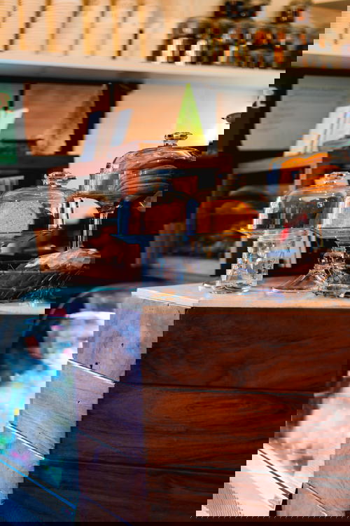 Glass coverings used on glass footed pastry cake stands at a coffee shop counter