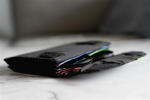 A black wallet sitting on top of a marble table.