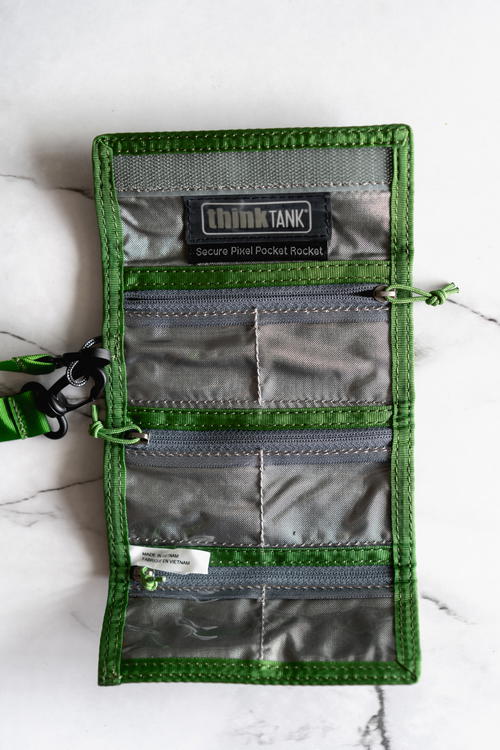 A green wallet with a lanyard attached to it.