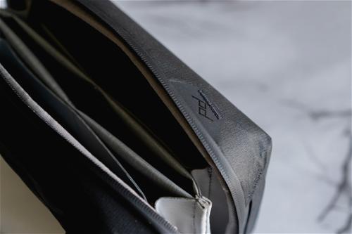 A close up of a black and white laptop bag.