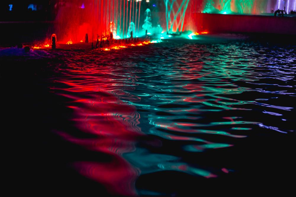 Red green and purple lights on water fountain in Parque de la Reserva in Lima Peru