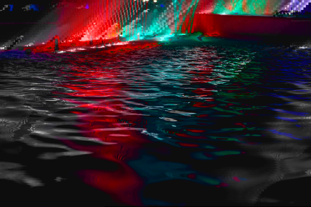 Red green and purple lights on water fountain in Parque de la Reserva in Lima Peru