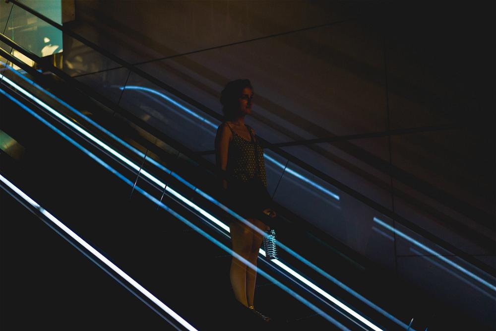 Woman on escalator at mall in Hong Kong Causeway Bay night photography