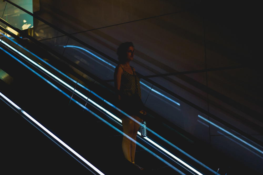 Woman on escalator at mall in Hong Kong Causeway Bay night photography