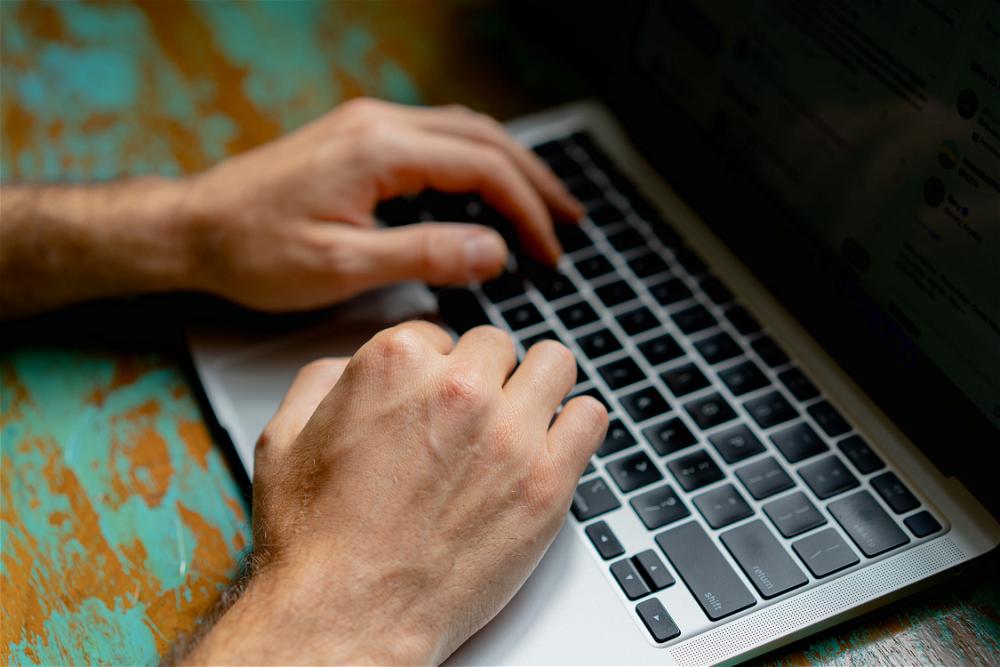 A man typing on a laptop.