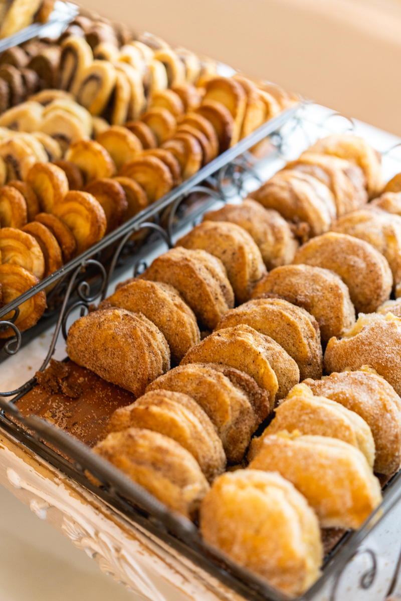 Trays of cookies are on display at a wedding.