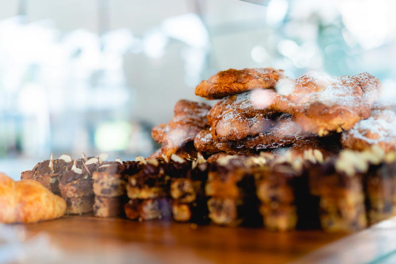 A display of pastries in a glass case.