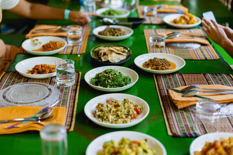 A group of people sitting at a table with plates of food.