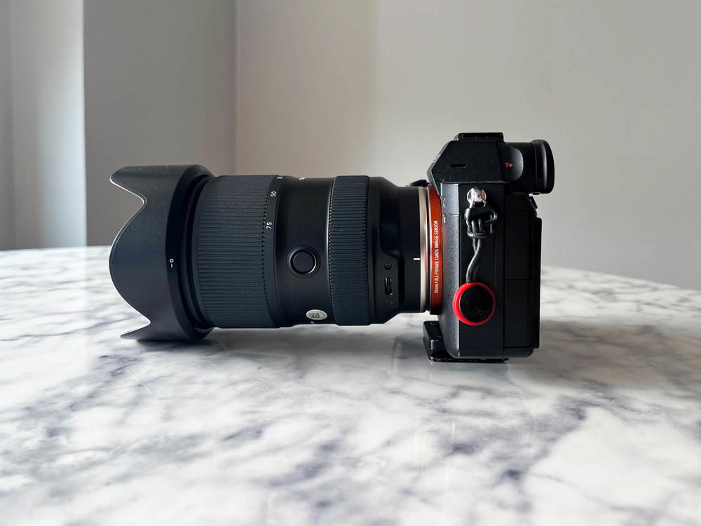 A black camera sitting on top of a marble table.