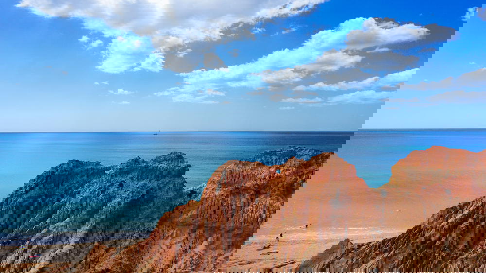 Beach and red rocks off the south coast of Portugal