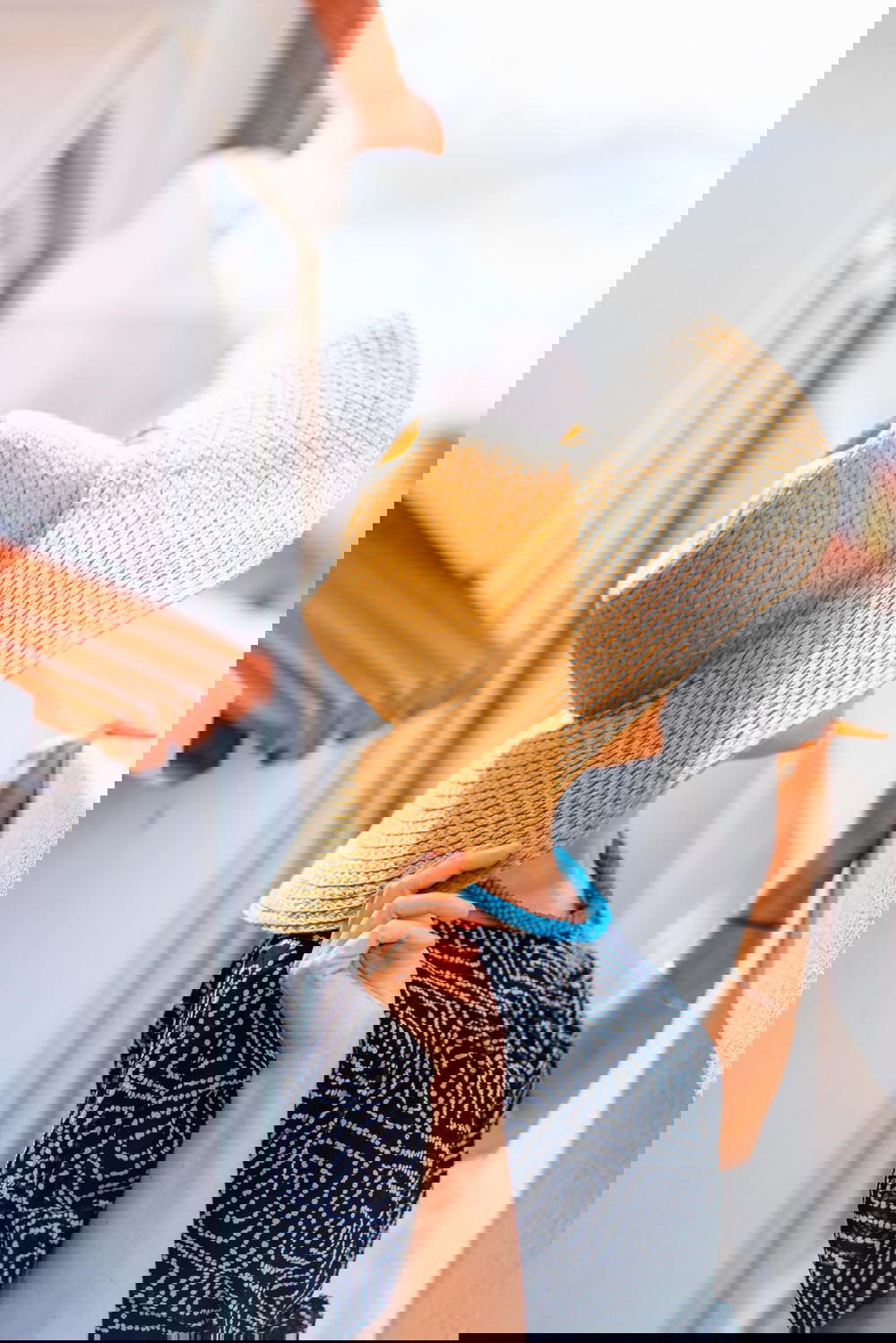 A woman wearing a hat on a balcony.