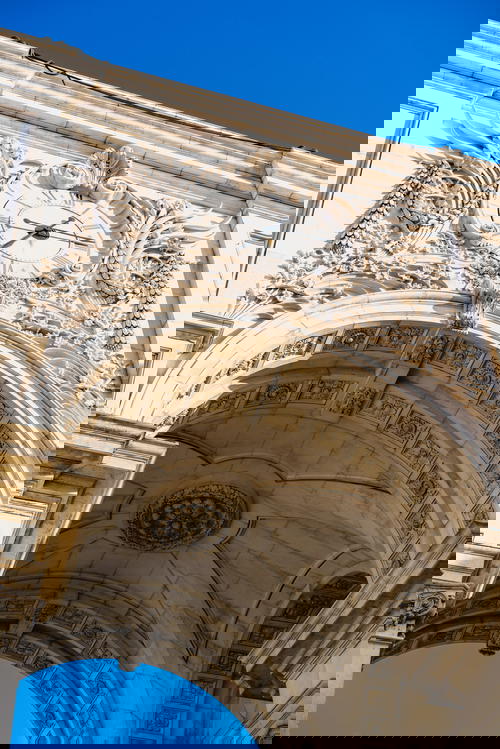 An archway with a clock on it.