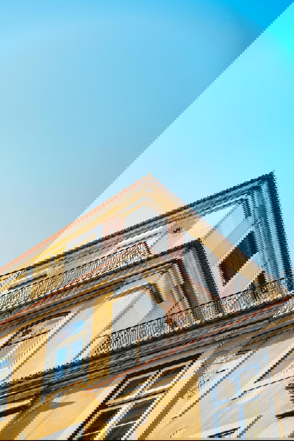 A yellow building with a blue sky.