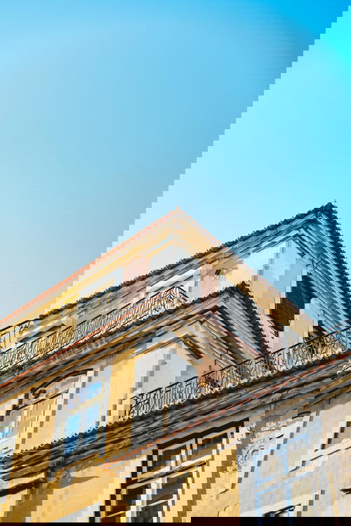 A yellow building with a blue sky.