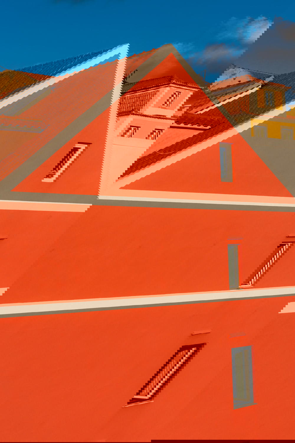 An orange building with a clock on it.