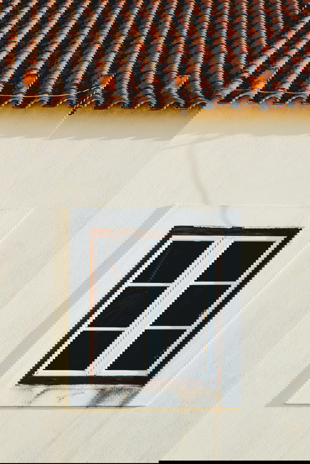 A window with a tiled roof.