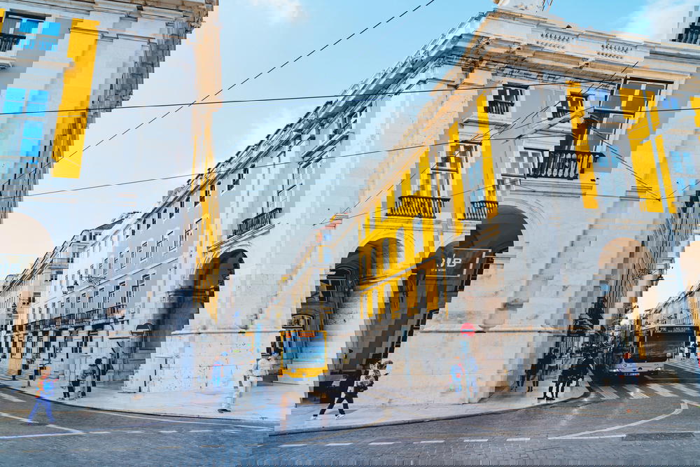 A yellow bus driving down a city street.