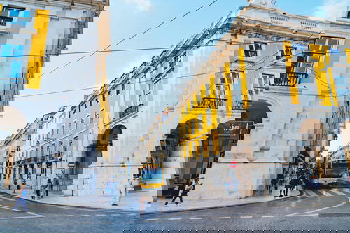 A yellow bus driving down a city street.