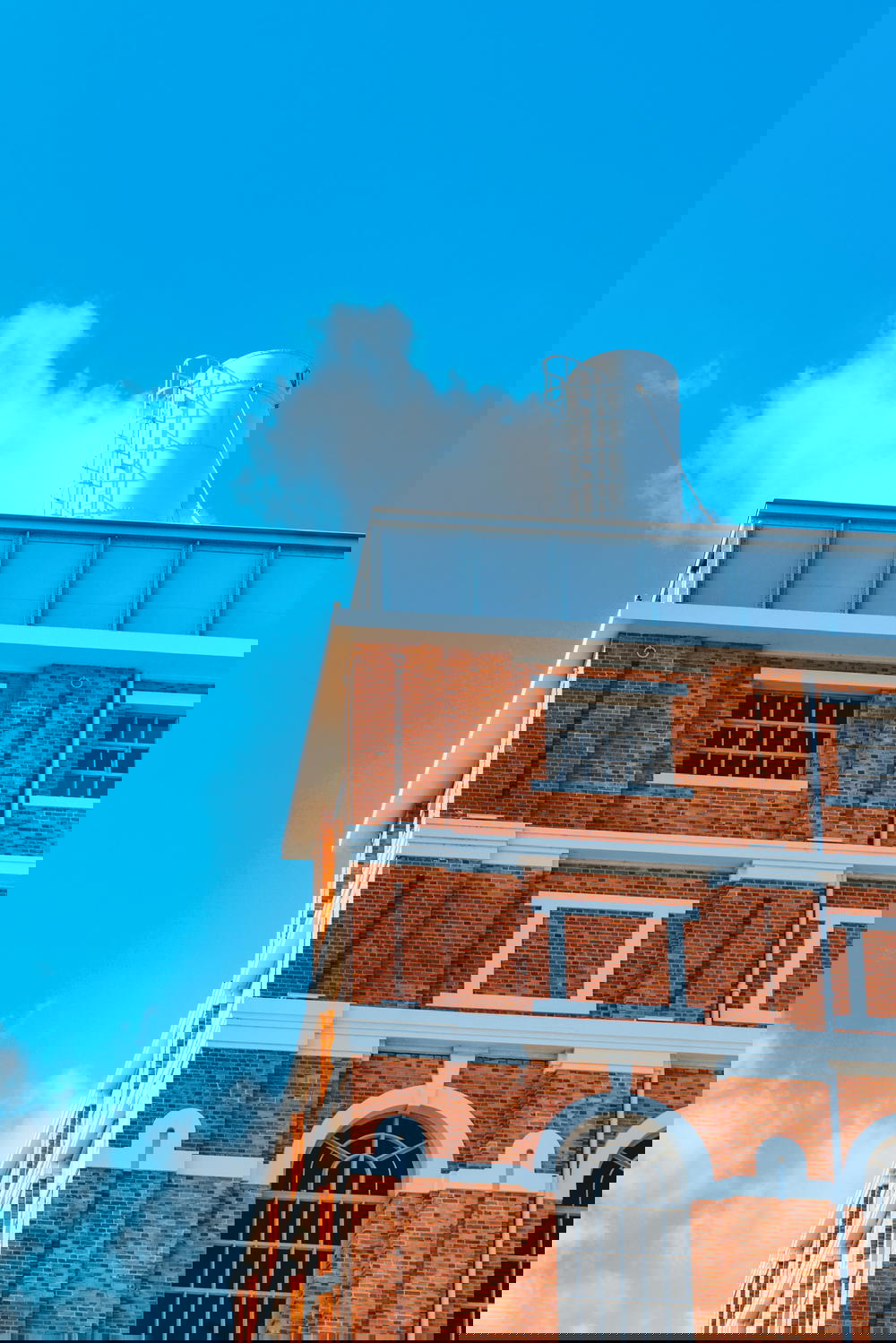 A brick building with a clock on top.