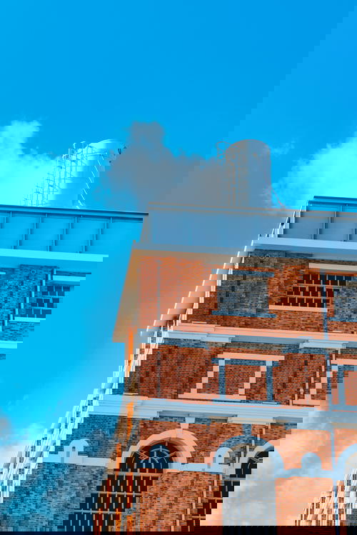 A brick building with a clock on top.