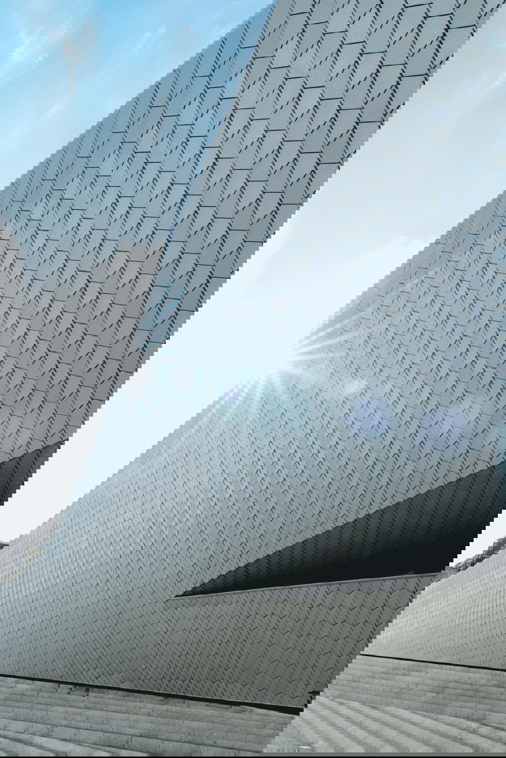 A white building with a sun shining on it.