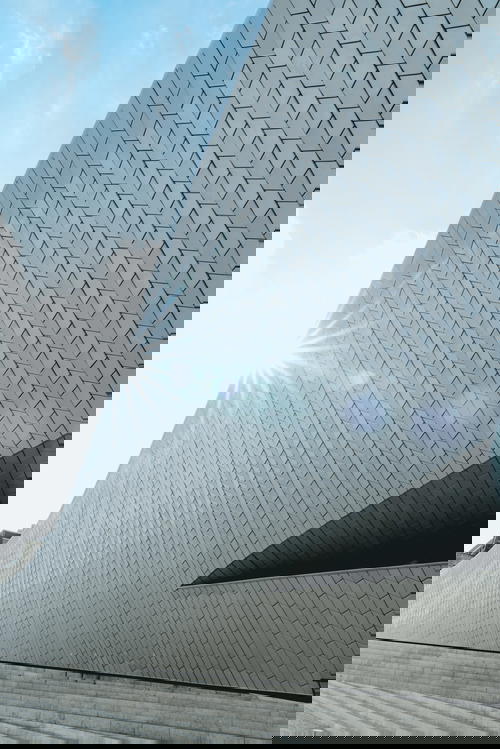 A white building with a sun shining on it.