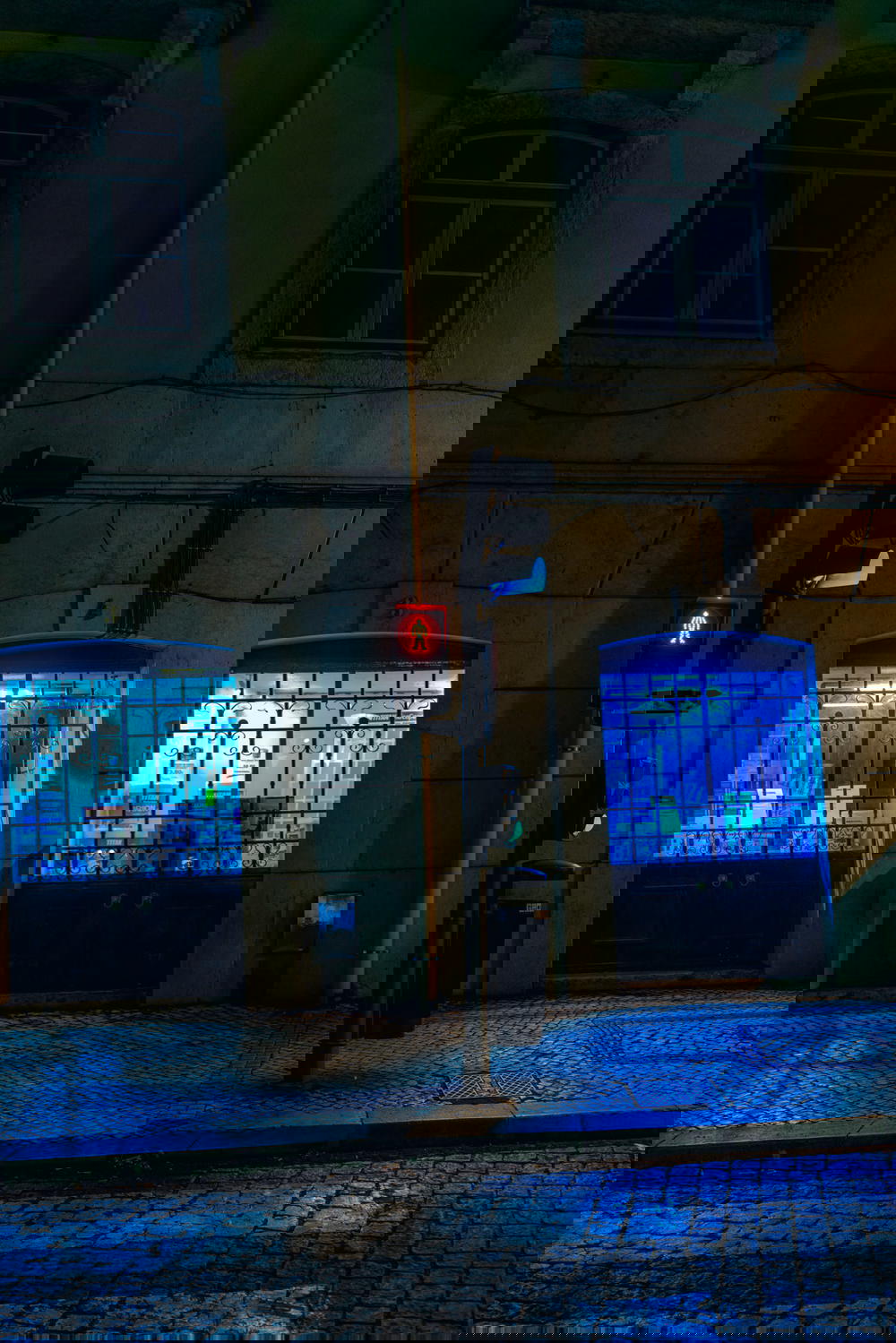 A building with a traffic light on it at night.