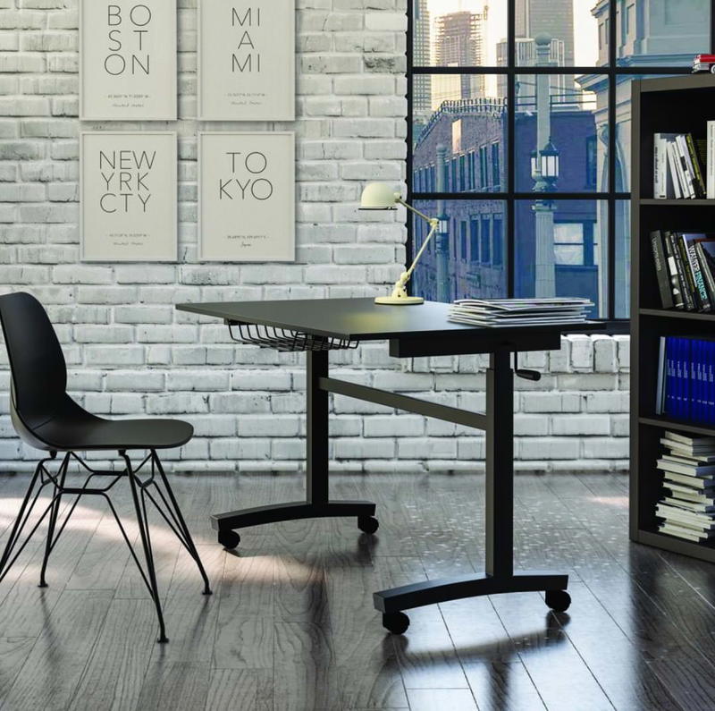 A black desk and chair in a room with a window.