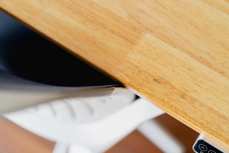 A close up of a wooden desk surface.