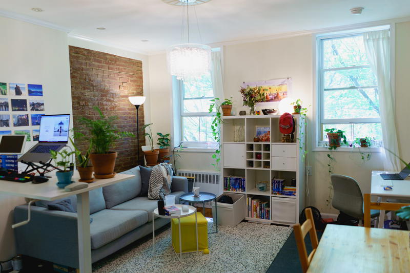 Home office for two design in a small nyc apartment with a standing desk and small compact desk in a living room