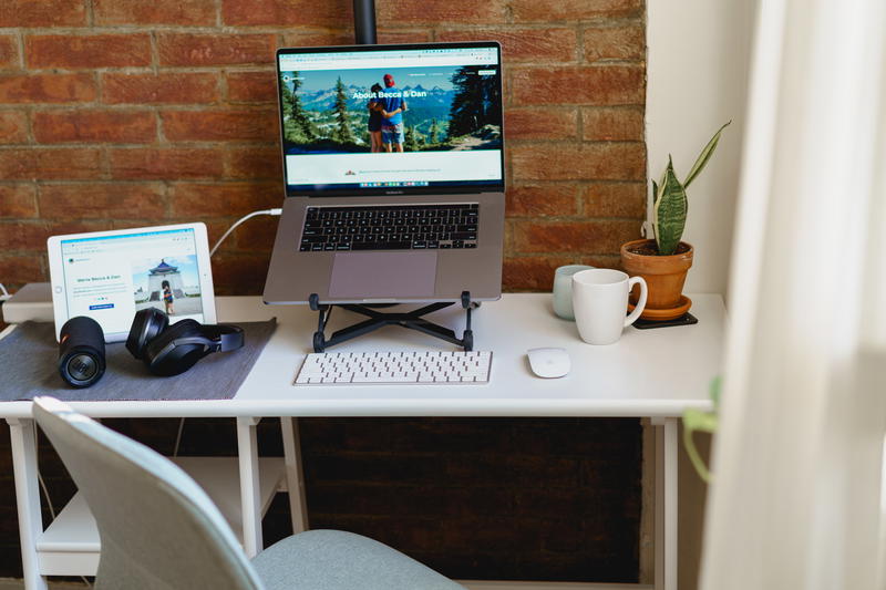 Home office setup in small apartment corner of living room with natural light