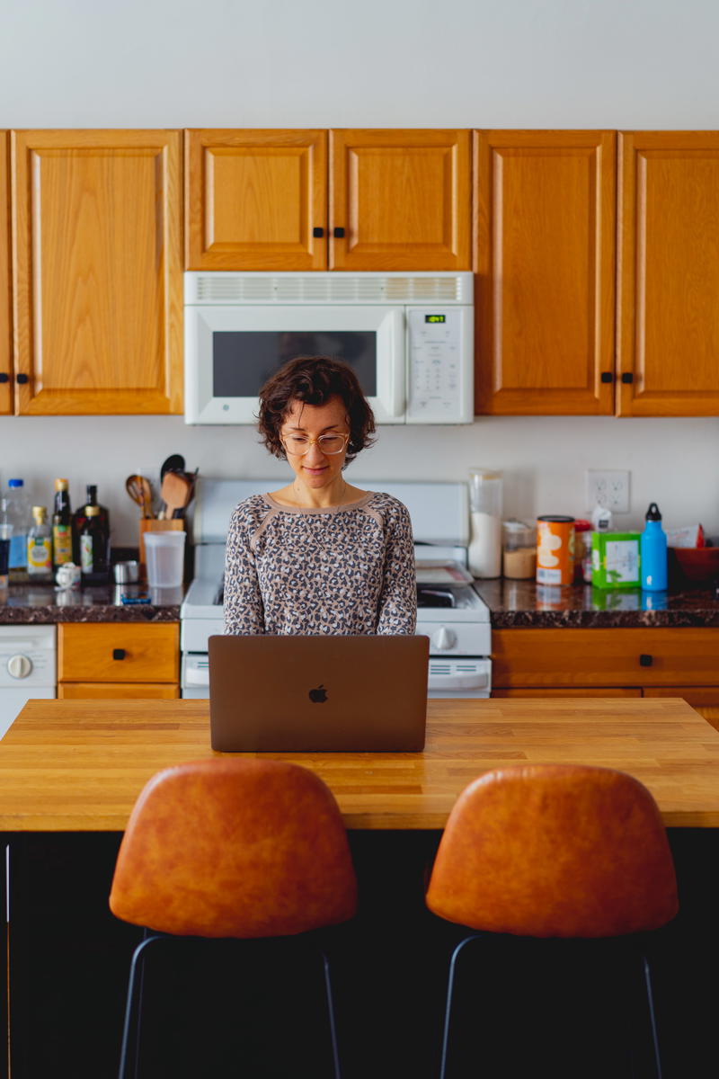 Woman working with a laptop in a kitchen