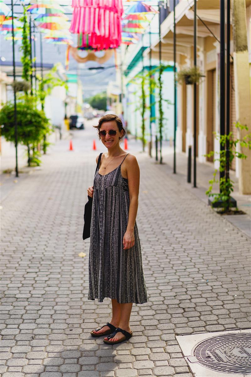 Woman posing for photo at Instagram spot Umbrella Street in Puerto Plata city Dominican Republic