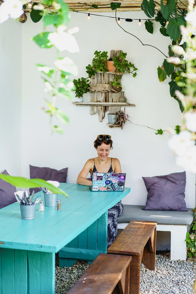 Woman using Dell XPS on a team table outside at a cafe