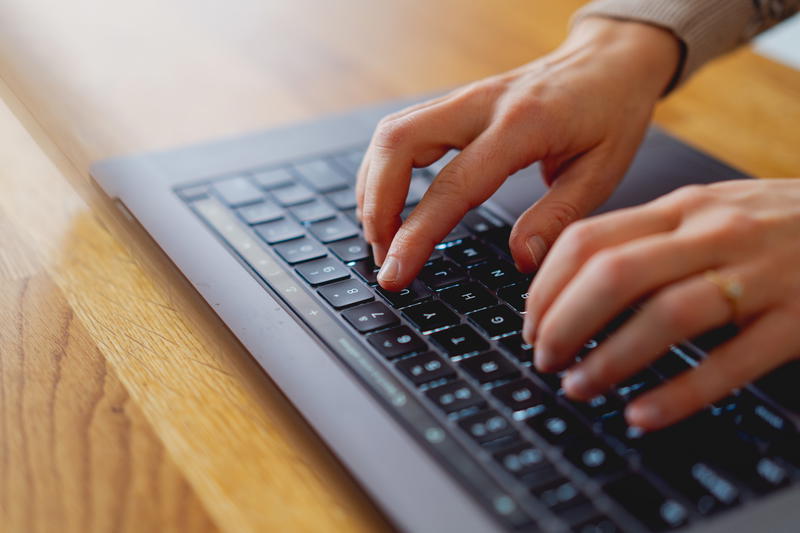 Woman typing on an Apple MacBook Pro 16"