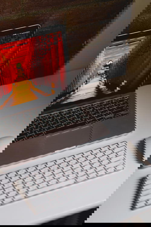 MacBook Pro and Apple Magic Keyboard with a bluetooth wireless mouse in a home office setup
