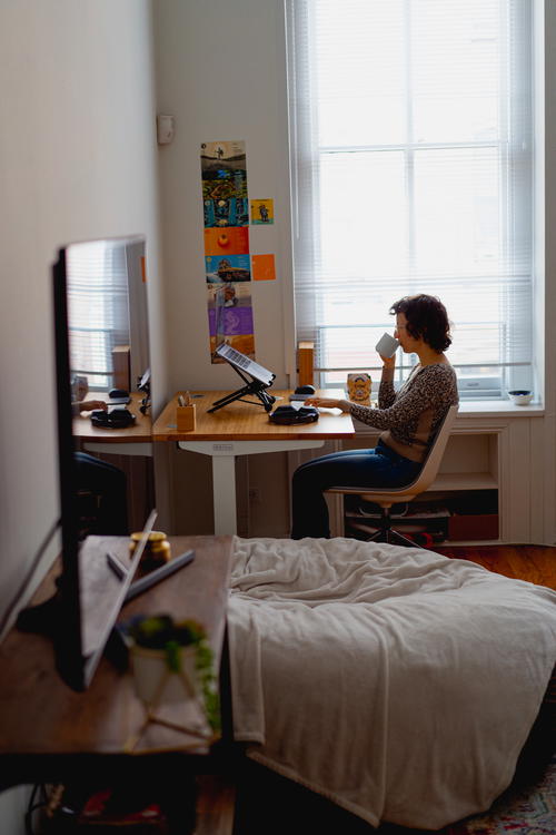 Woman working at a desk in front of a window