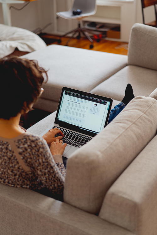 Woman working on a couch