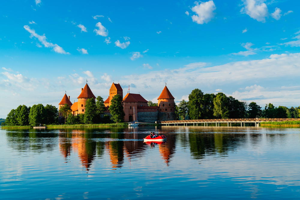 A boat is in the water near a castle.