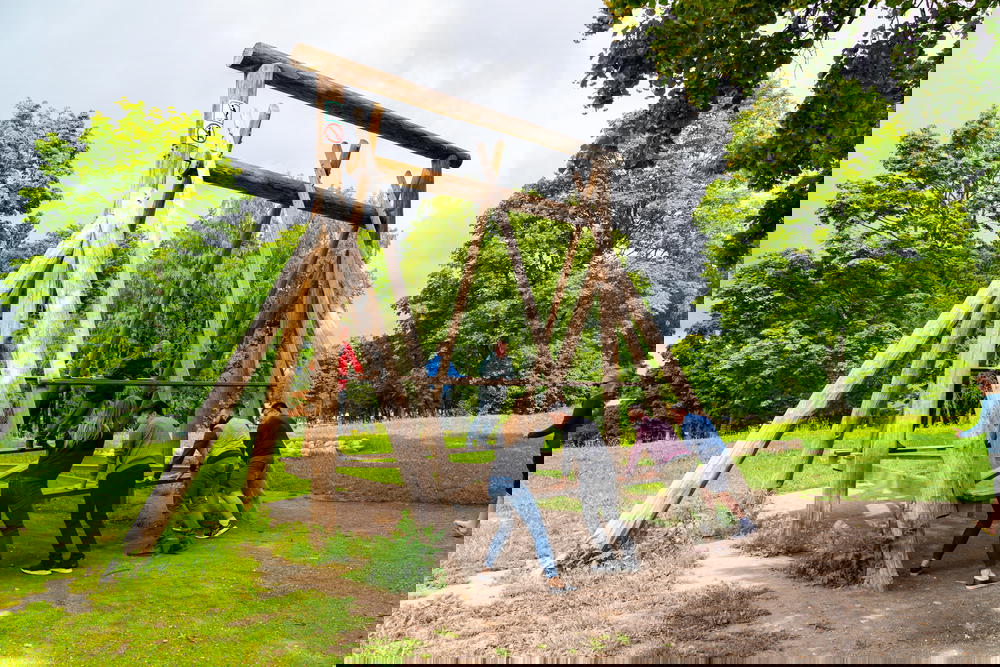 A group of people on a swing set.