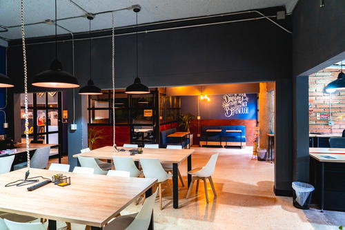Open area with desks and chairs in the Selina Medellin coworking space