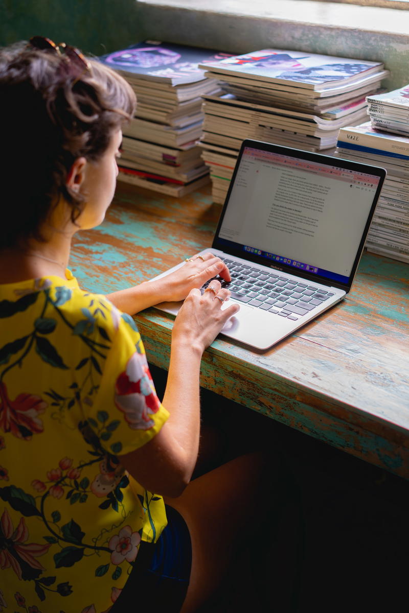 A woman sitting at a desk with a laptop.