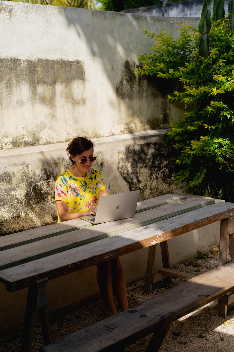 A woman sitting at a picnic table.