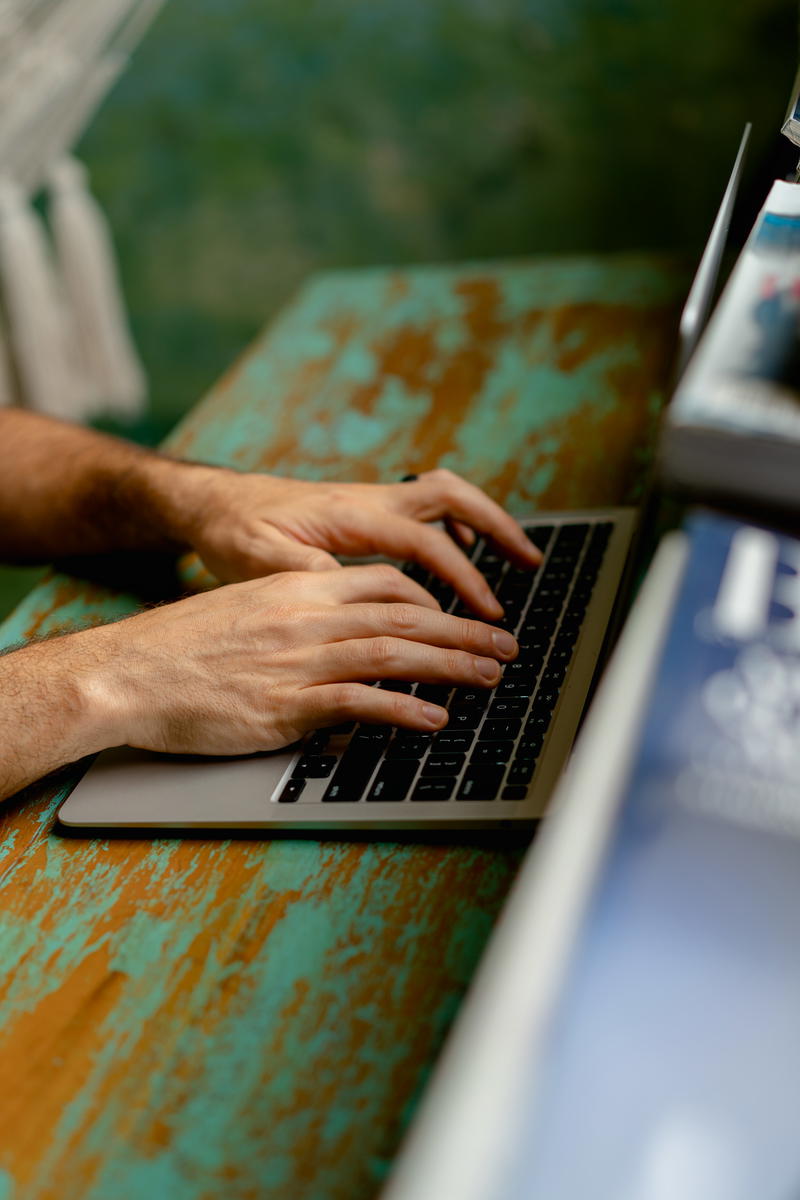 A man typing on a laptop.