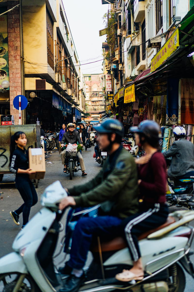 A group of people on a scooter.