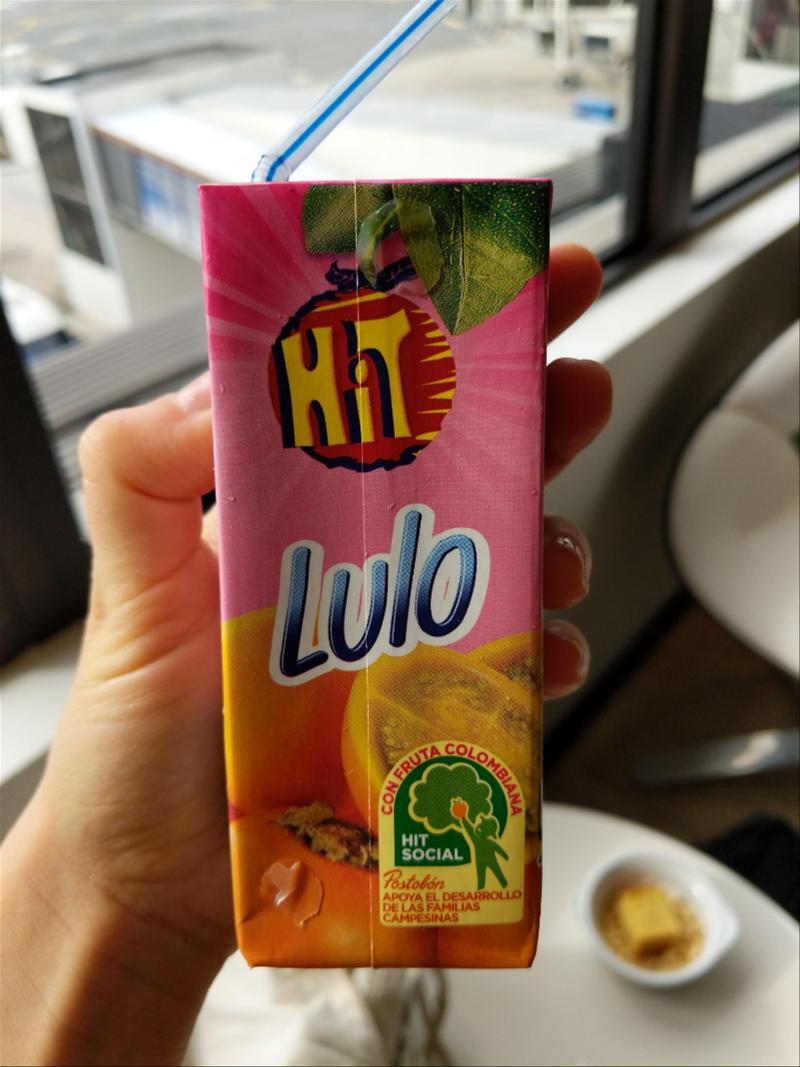 A person holding a box of hulo juice.