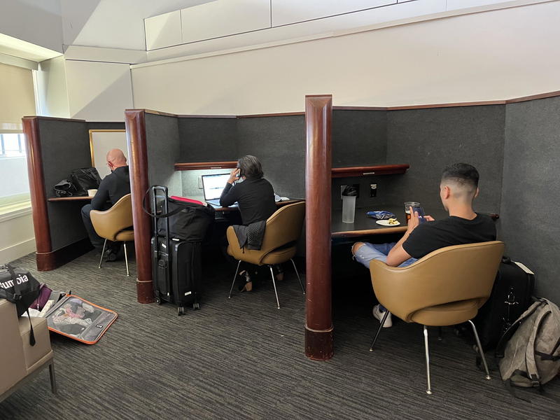 A group of people sitting at desks in a room.