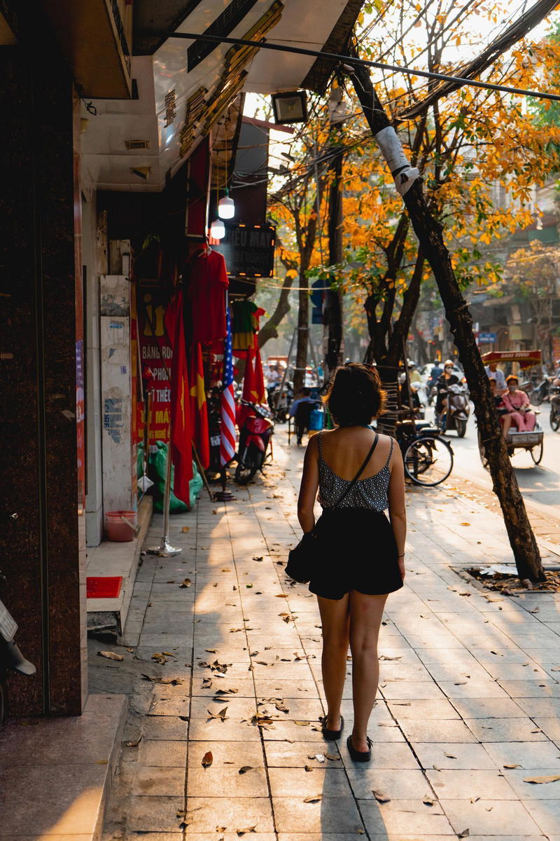 A woman walking down a sidewalk.