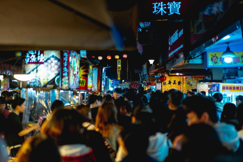 A crowd of people walking down a street.