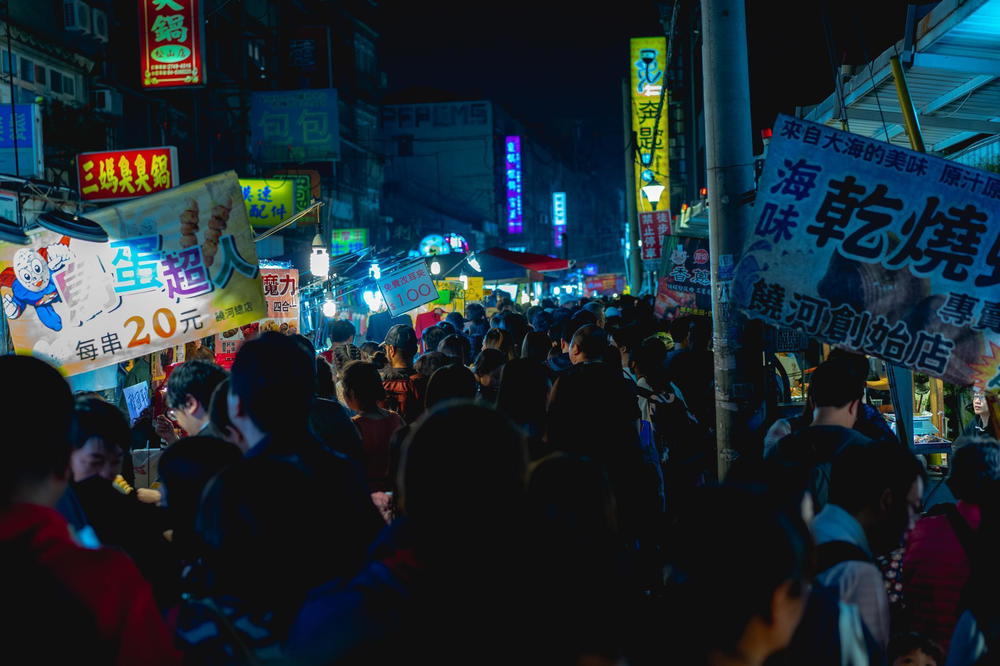 A crowd of people walking down a street.